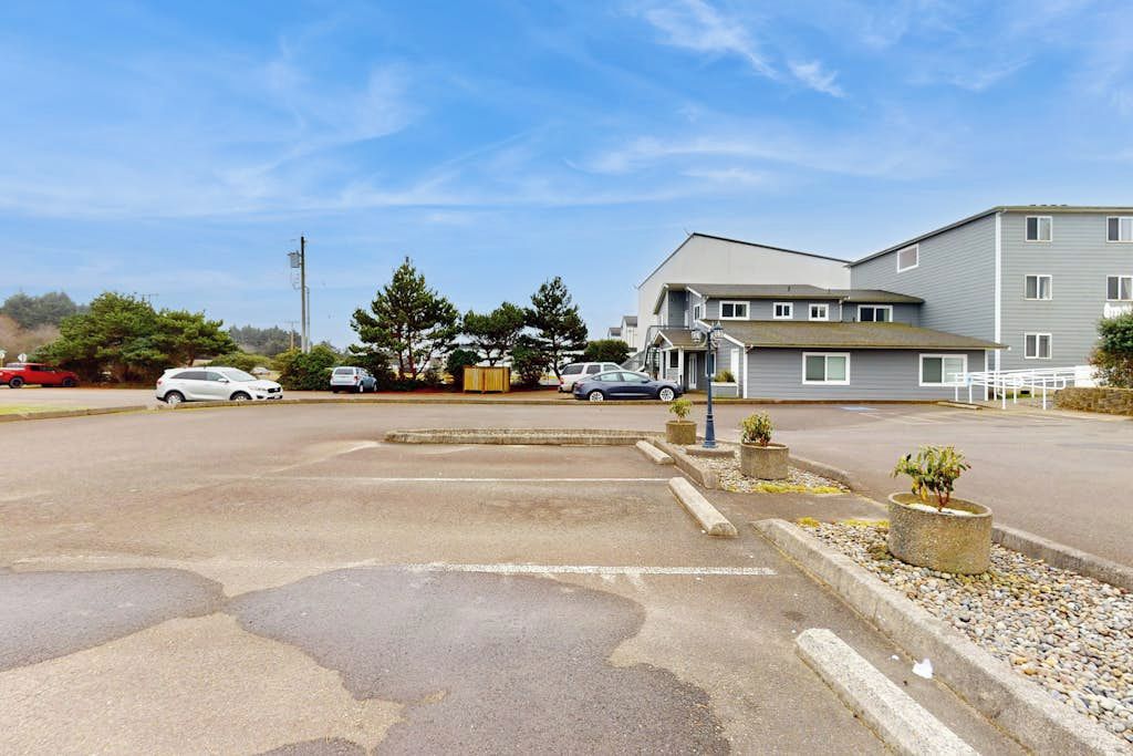 A parking lot with a building in the background.