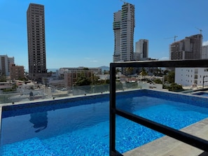 A swimming pool with a view of surrounding high-rise buildings.
