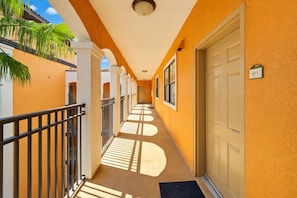 Bright sunny walkway leads to your door, where warm tropical breezes and swaying palms welcome you to your vacation escape. - 2BR Disney Condo | FREE Resort Access & Parking (Orlando)