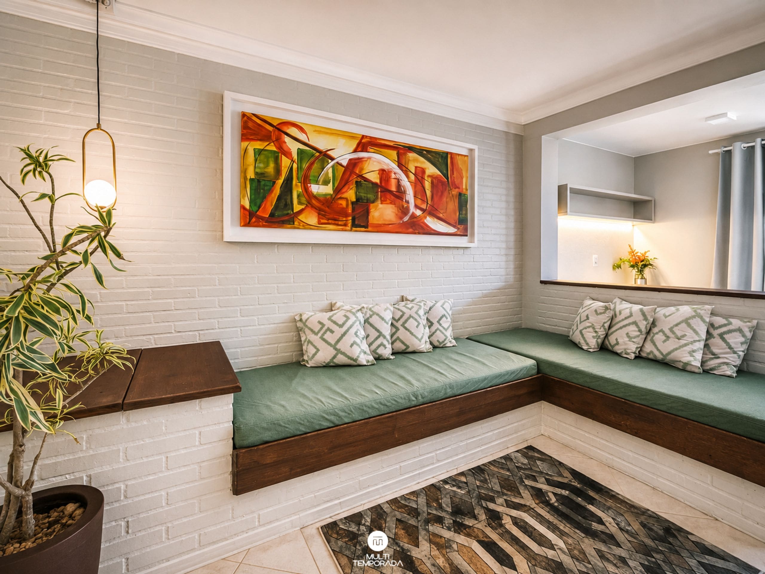 A modern living room with a sectional sofa, a large abstract painting, a potted plant, and a patterned rug.