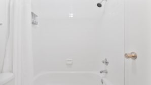 A bathroom with a bathtub, shower, and toilet. - Stylish Mesa 2BR • Perfect for ASU Visits (Mesa)