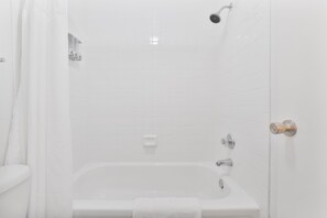 A bathroom with a bathtub, shower, and toilet. - Stylish Mesa 2BR • Perfect for ASU Visits (Mesa)