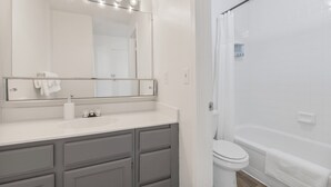 A bathroom with a mirror, sink, and toilet. - Stylish Mesa 2BR • Perfect for ASU Visits (Mesa)