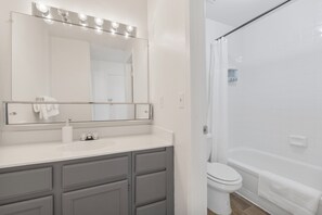 A bathroom with a mirror, sink, and toilet. - Stylish Mesa 2BR • Perfect for ASU Visits (Mesa)