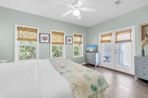 A bedroom with a bed, a dresser, a television, and windows with blinds. - Pineapple Under the Sea– Great Florida Cottage Near 30A Beaches (Santa Rosa Beach)