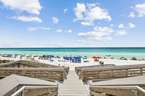 A wooden boardwalk leading to a beach with umbrellas and beach chairs. - 🐚 Gone Coastal | Private Heated Pool + Hot Tub | Bikes | Fire Pit (Santa Rosa Beach)
