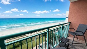 Un balcon avec vue sur la plage et l’océan.