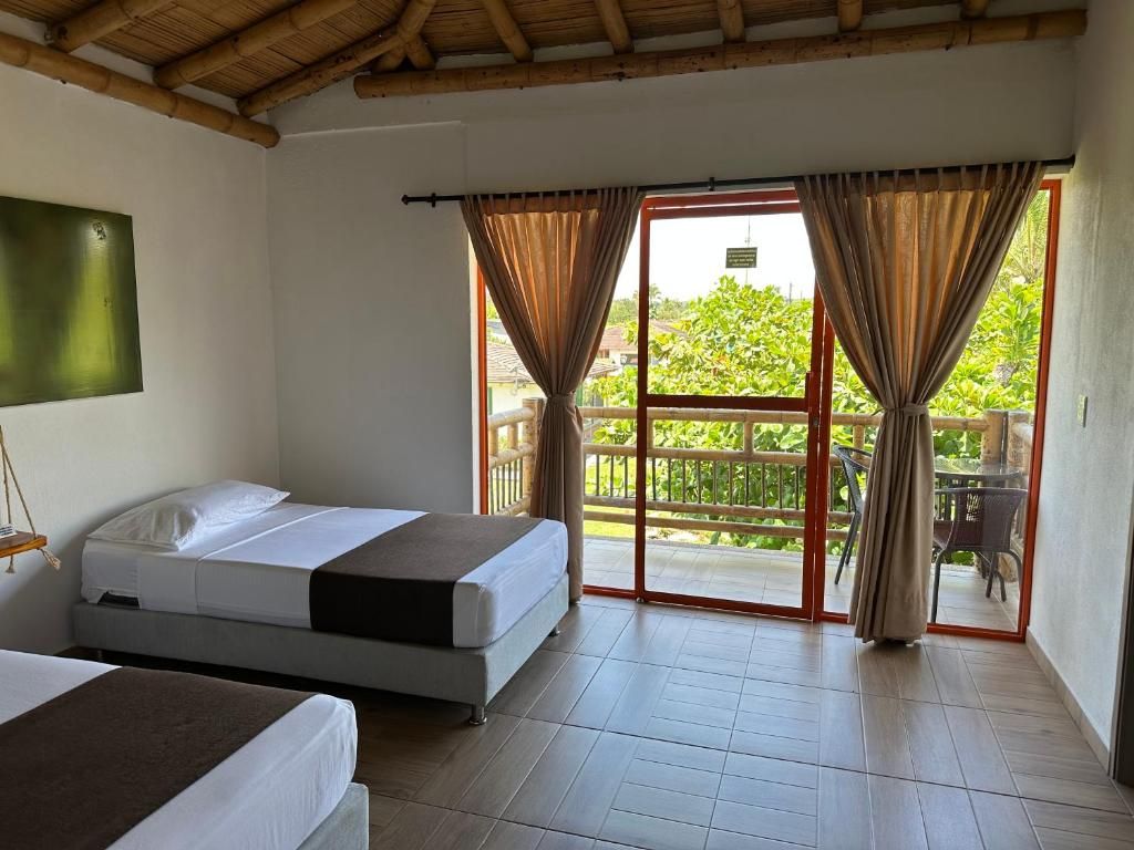 Een kamer met twee bedden, een balkon met uitzicht en een schuifdeur.