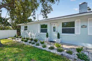 A single-story house with a front door, two windows, and a mailbox. - Completely Renovated, Private Dock & Beach days, bay views! (Holmes Beach)