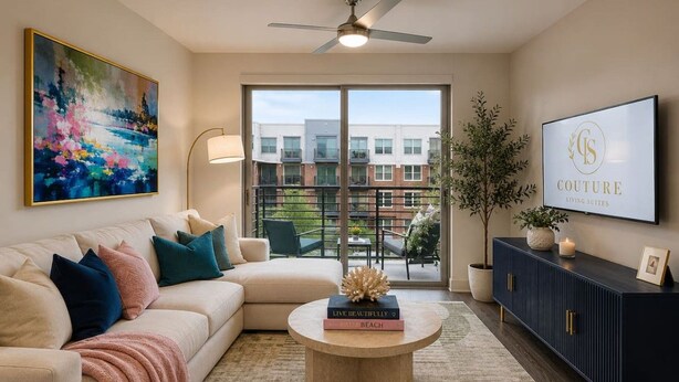 A living room with a sofa, coffee table, and a TV on a wall. - King Suite | Walk to Toyota Stadium | Pool + Gym (Frisco)