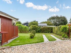 A residential property with a paved driveway, a wooden fence, and a well-maintained lawn. - "Laurine" - 500m from the sea by Interhome (Sydals)