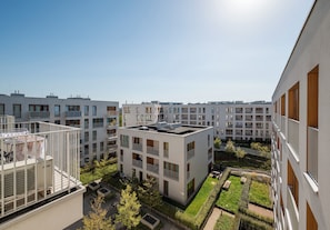 A modern apartment complex with multiple buildings, balconies, and a central courtyard with greenery. - Mokotów Residence Apartment (Warszawa)