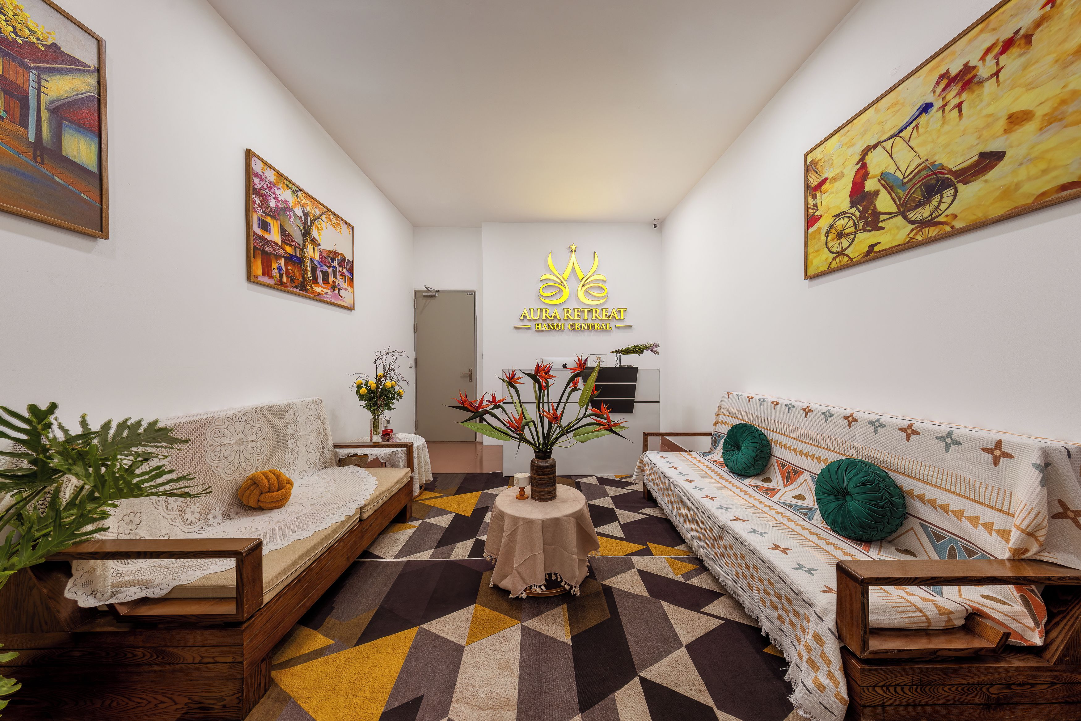 A modern living room with a sofa, a coffee table, and a painting on the wall.