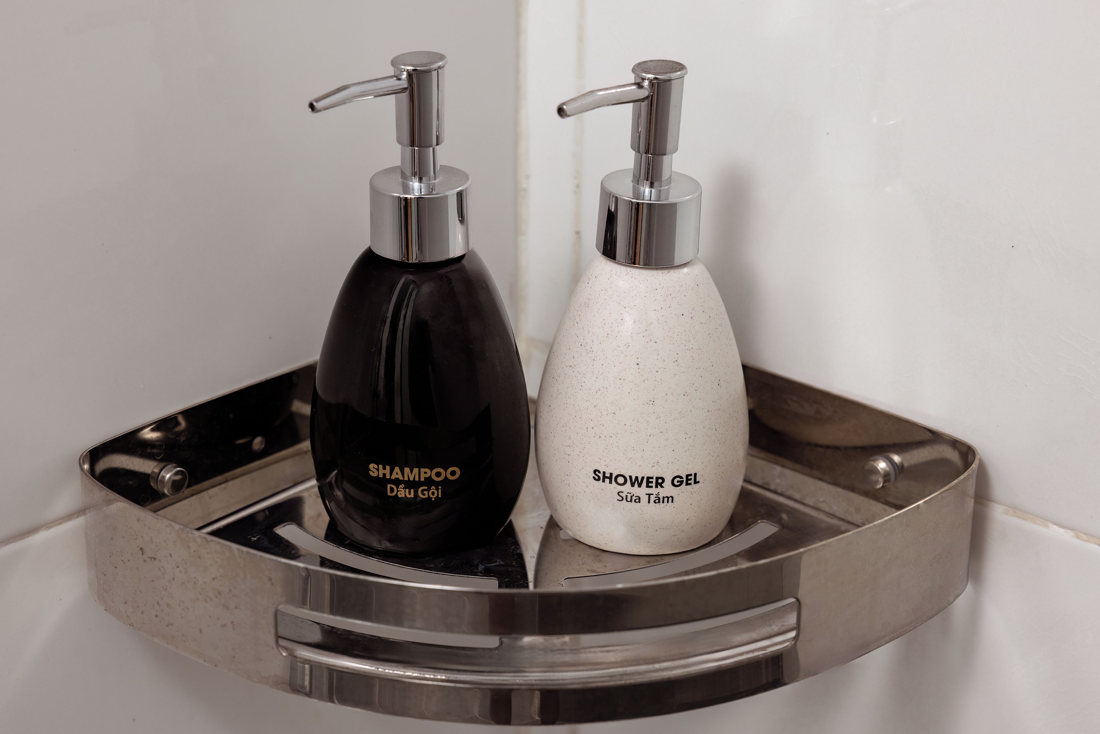 Two toiletry bottles on a metallic tray.