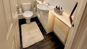 Un baño pequeño con inodoro, lavabo y espejo.