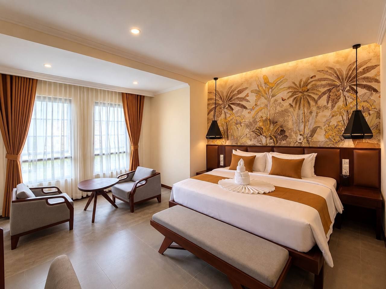 A hotel room with a large bed, a desk, a chair, and a bench.