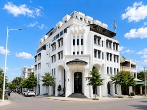 A large, white, multi-story building with a prominent entrance and a satellite dish on the roof. - La Maison Siem Reap (Siem Reap)