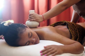 A person receiving a massage with a stone on their back. - La Maison Siem Reap (Siem Reap City Center)