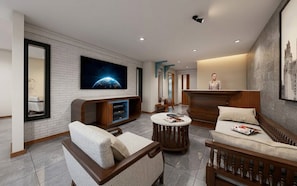A modern hotel lobby with a reception desk, seating area, and a large flat-screen TV mounted on the wall. - La Maison Siem Reap (Siem Reap)