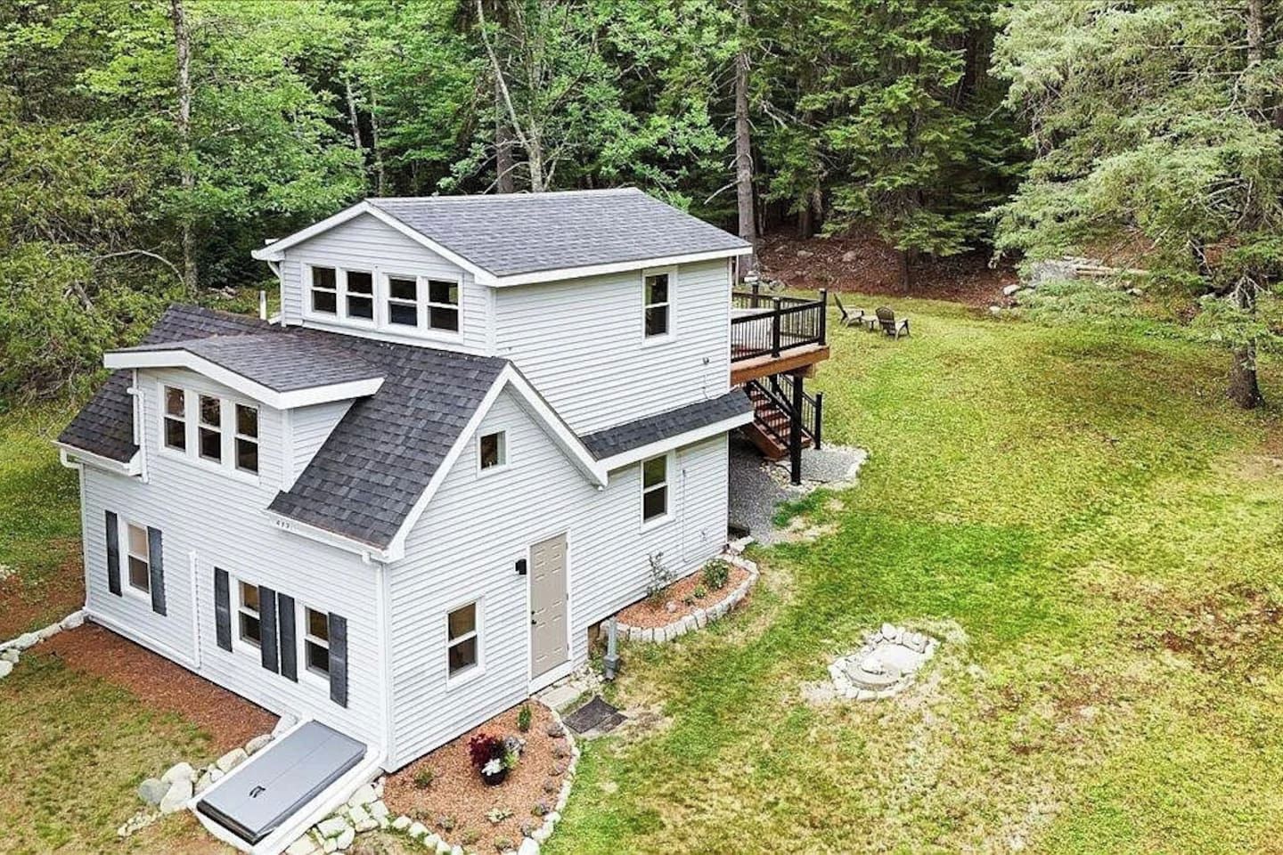 A two-story house with a deck and a garage.