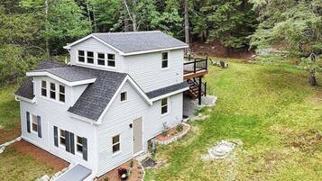 A two-story house with a deck and a garage.