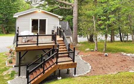 A two-story house with a deck and a staircase.
