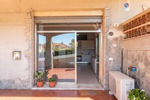 A residential entrance with a sliding glass door leading to a kitchen area. - Casa Giulia, Ceriale, Italy (Ceriale)