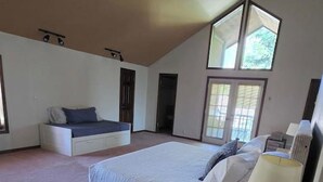 A bedroom with a large bed, a nightstand, a dresser, and a window. - 5-BR Family Retreat – Pool Table & Waffles (Provo)