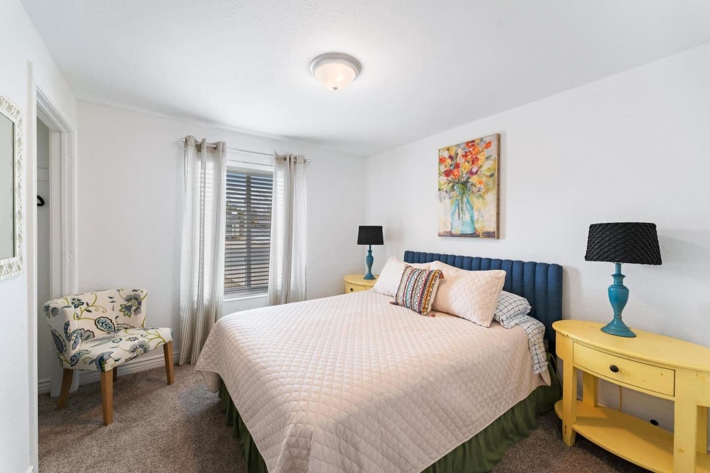 Main floor queen bedroom with cheerful pops of color
