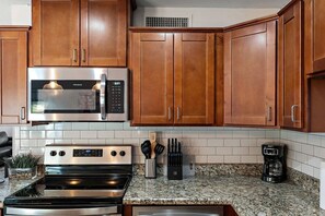 A kitchen with wooden cabinets, a stainless steel microwave, an oven, and a coffee maker. - Scottsdale Monterosa 🌵⛳ Private Pool, Putting Green Near Old Town Scottsdale (Scottsdale)
