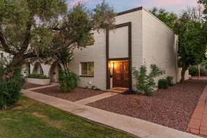 A modern building with a white facade, a central entrance, and a small porch area. - Scottsdale Miller Townhome 🌵⛳ Walk to Old Town, Gated Pool & Firepit (Scottsdale)