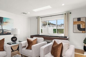 A modern living room with a piano, a large window with curtains, and a view of the outside. - Luxury Oasis, 3min to Oldtown! 4bd4Ba HtdPool&Spa! (Scottsdale)