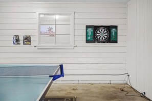 A room with a dartboard, a window with a view, and a ping pong table. - Scottsdale Old Town Lewis 🌵⛳ Private Hot Tub Near Old Town & the Zoo (Scottsdale)