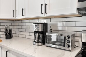 A kitchen with white cabinets, a coffee maker, and a toaster. - Scottsdale Andora Retreat 🌵⛳ Heated Saltwater Pool Near Kierland Commons (Phoenix)