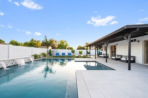 A swimming pool with a waterfall feature, surrounded by a covered patio area with seating. - Scottsdale Andora Retreat 🌵⛳ Heated Saltwater Pool Near Kierland Commons (Phoenix)