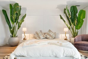A bedroom with a large bed, two bedside tables with lamps, a chair, and two large potted plants. - Scottsdale Andora Retreat 🌵⛳ Heated Saltwater Pool Near Kierland Commons (Phoenix)