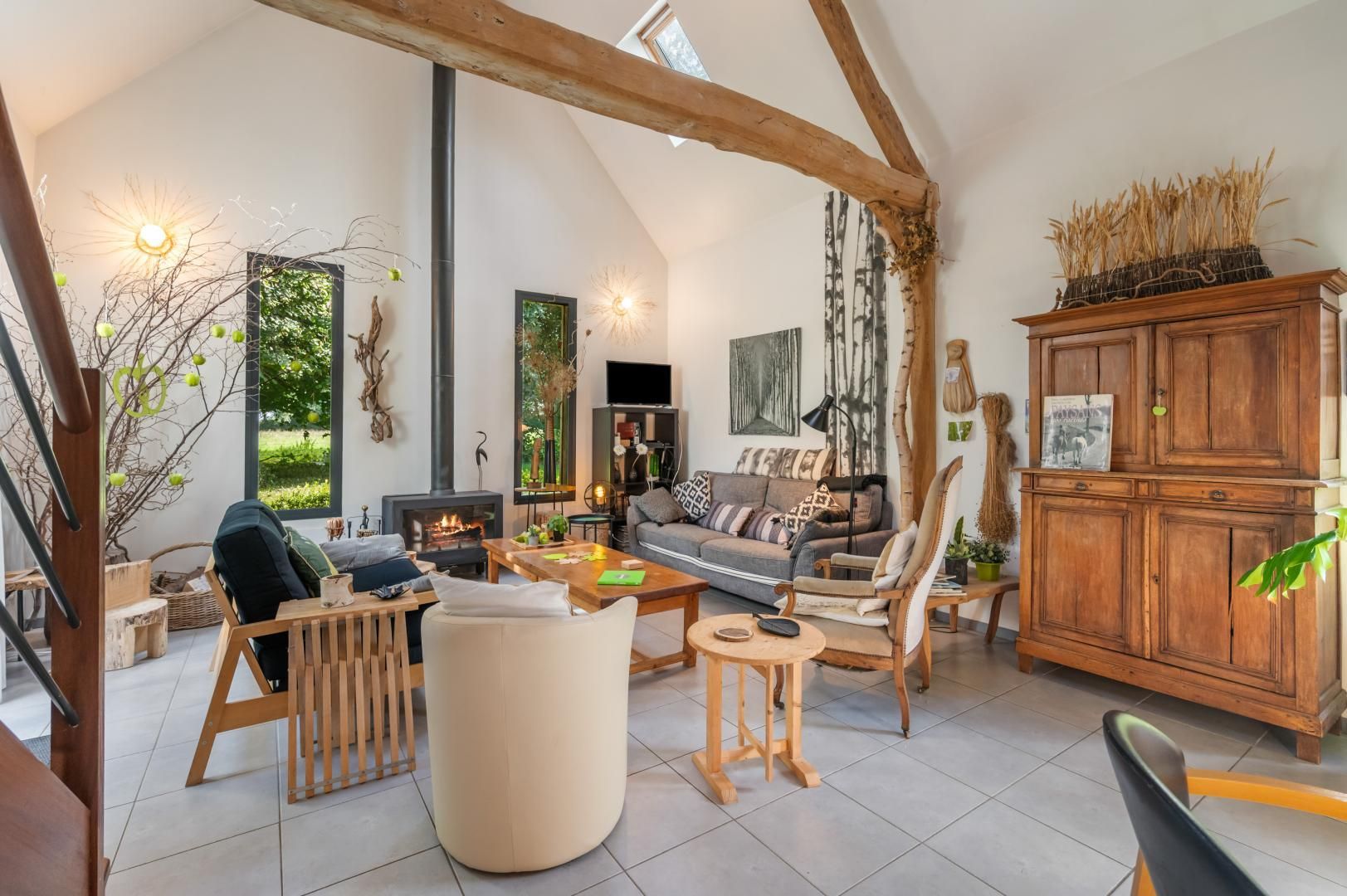 A spacious living room with a fireplace, comfortable seating, and a view of the outdoors.