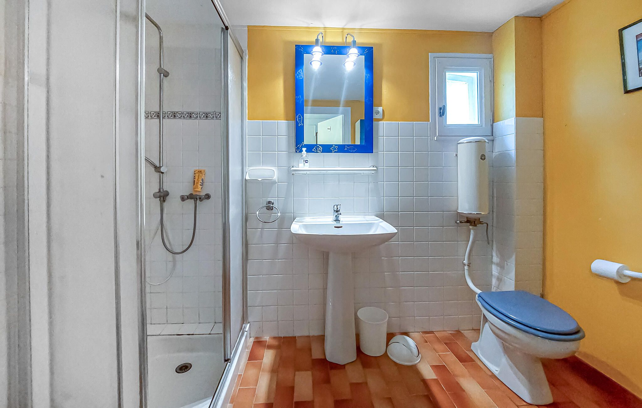 A bathroom with a shower, sink, and toilet.