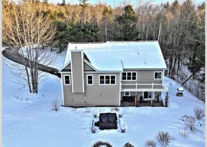 A two-story house with a covered porch and a garage.