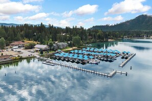 A lakeside marina with docked boats and a small building.