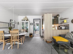 A modern living space with a dining area, kitchen, and seating area. - "Maureen" - 150m from the sea by Interhome (Haderslev)