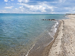 A beach with clear water, pebbles, and a distant shoreline. - "Joachim" - 10m from the sea by Interhome (Otterup)