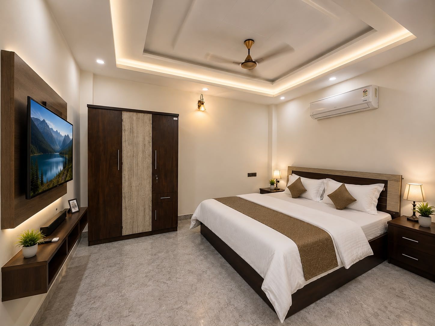 A hotel room with a large bed, a TV mounted on the wall, a wardrobe, and an air conditioning unit.