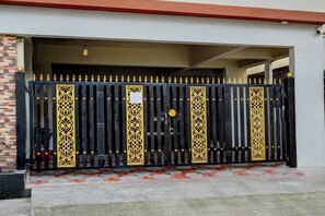 A gated entrance with a decorative metal fence and a brick wall. - Townhouse Element Mall Bangalore (Bengaluru)