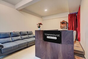 A reception area with a black sign reading 'TOWNHOUSE Company Serviced.' - Townhouse Element Mall Bangalore (Bengaluru)