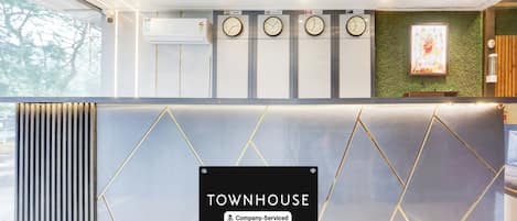 A reception area with a sign reading 'TOWNHOUSE Company Serviced.'