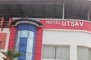 A building with a sign that reads 'HOTEL UTSAV.' - Hotel Utsav & Resto Cafe (Dehradun)