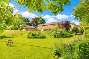 A stone building with a grassy yard and garden. - Stonethwaite, Dalston - a luxurious, dog friendly, romantic barn conversion (Dalston)