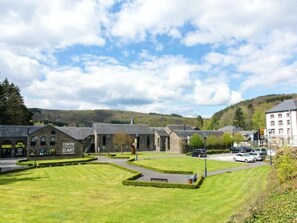 A Centre D'Art with a grassy courtyard, stone buildings, and a hilly backdrop. - Pretty gite with terrace near the Semois river (Alle-sur-Semois)