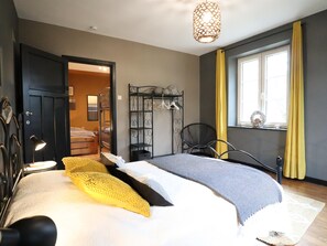 A bedroom with a bed, a wardrobe, a chair, a hanging light fixture, and a window with curtains. - Pretty gite with terrace near the Semois river (Alle-sur-Semois)